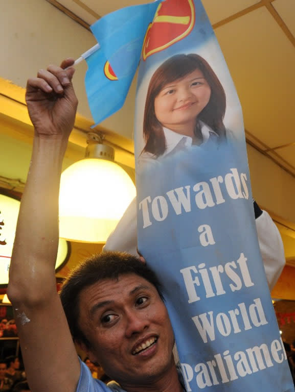 A Workers' Party supporter celebrates after the results for the Punggol east by-election was announced.