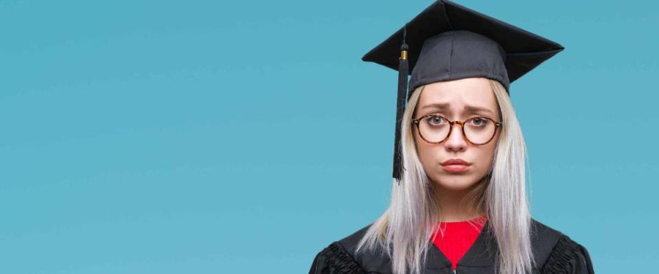 Young blonde woman wearing graduate uniform over isolated background depressed and worry for distress, crying angry and afraid. Sad expression.