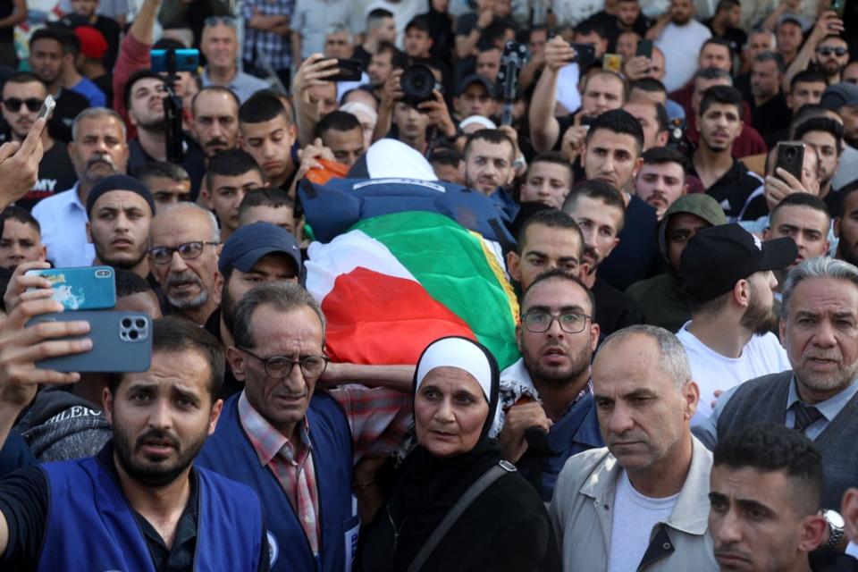 Mourners carry the body of veteran Al Jazeera journalist Shireen Abu Akleh during her funeral (AFP via Getty Images)