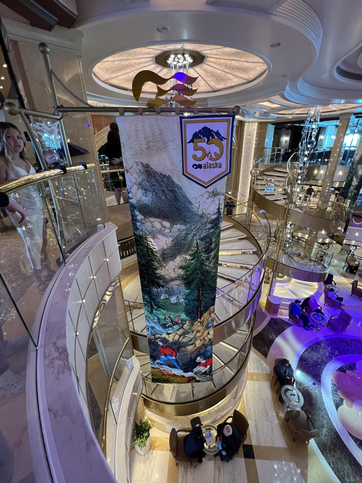 In the piazza-style atrium of the Discovery Princess, Alaska banners reminded us, even on days at sea, that we were not in the Caribbean. (Photo: Terri Peters)