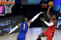 Toronto Raptors' Terence Davis, right, shoots against Philadelphia 76ers' Mike Scott during the second half of an NBA basketball game Wednesday, Aug. 12, 2020 in Lake Buena Vista, Fla. (AP Photo/Ashley Landis, Pool)