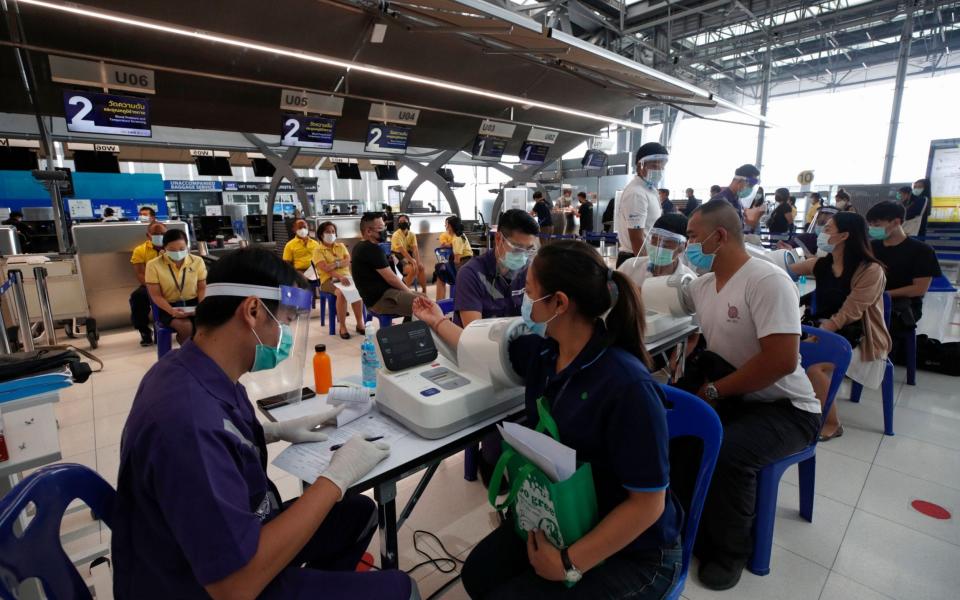 Airport staff members prepare to be vaccinated - Shutterstock