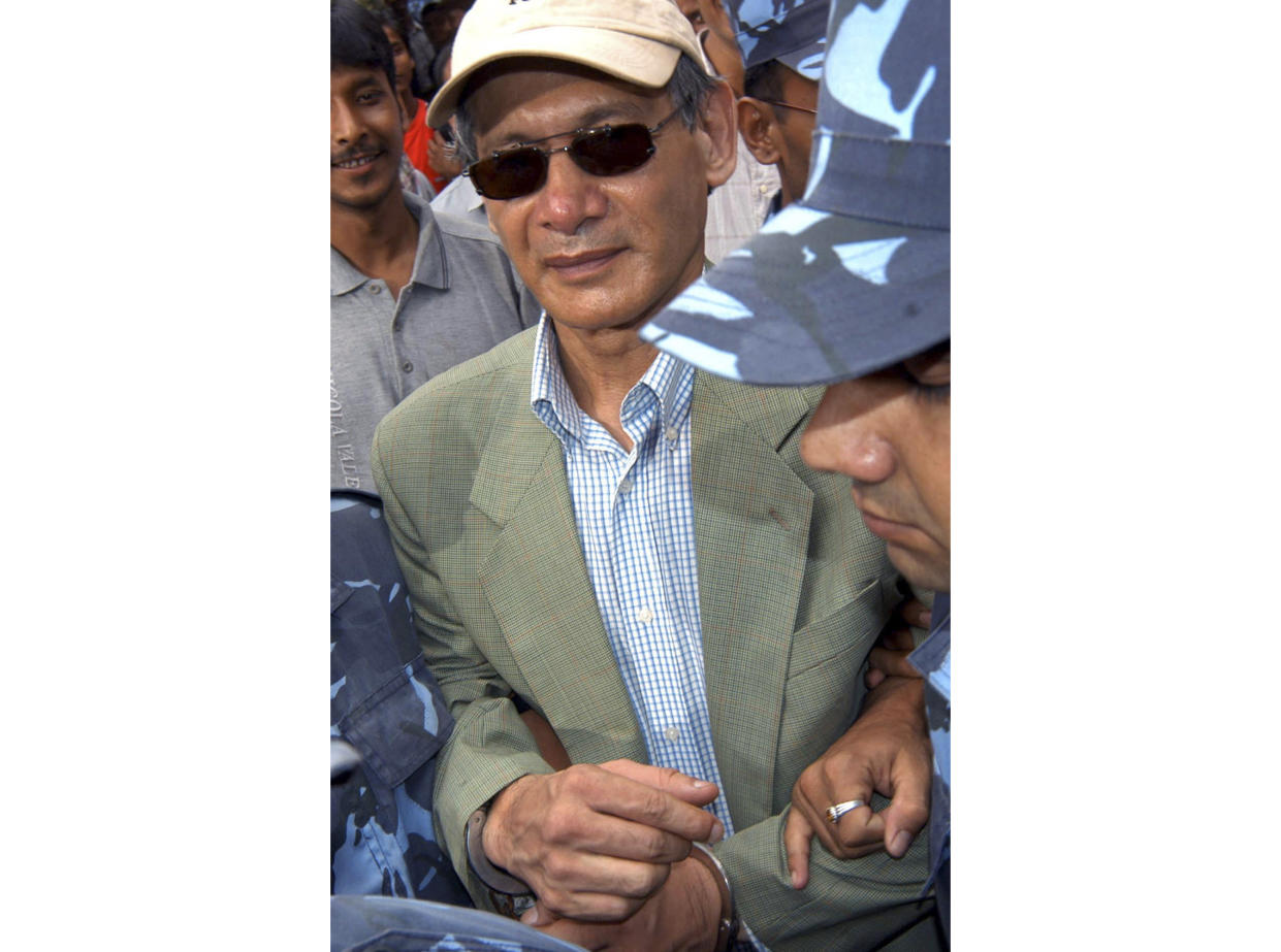 Charles Sobhraj is escorted by police from court in Katmandu, Nepal on Aug. 12, 2004. (AP)