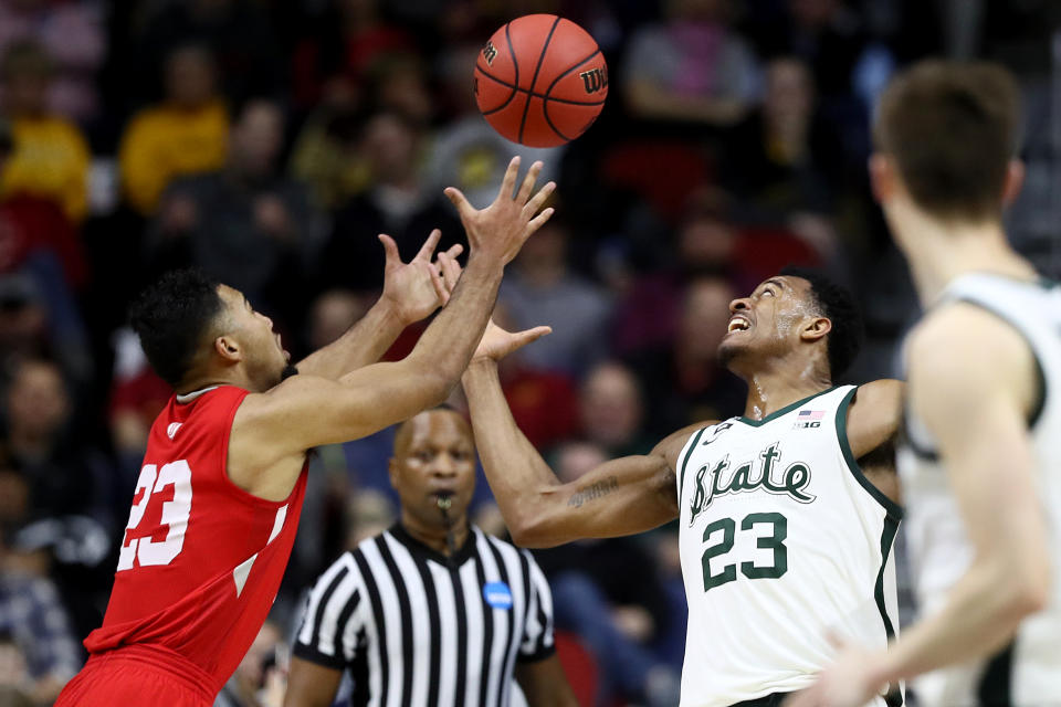 <p>Xavier Tillman #23 of the Michigan State Spartans and Dwayne Lautier-Ogunleye #23 of the Bradley Braves go after a loose ball during their game in the First Round of the NCAA Basketball Tournament at Wells Fargo Arena on March 21, 2019 in Des Moines, Iowa. (Photo by Jamie Squire/Getty Images) </p>