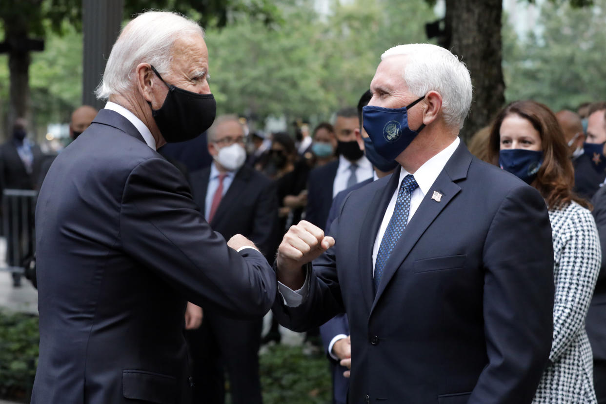 Former Vice President Joe Biden greets Vice President Mike Pence at the National September 11 Memorial & Museum in New York on Friday. (Amr Alfiky/The New York Times via AP, Pool)