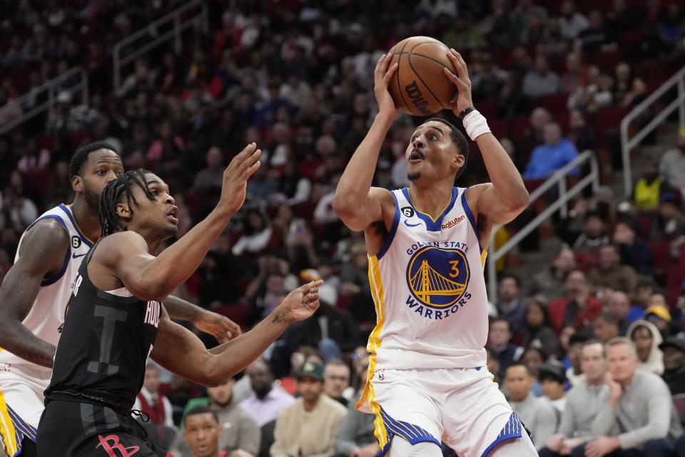 Golden State Warriors' Jordan Poole (3) looks to shoot as Houston Rockets' Josh Christopher, left, defends during the second half of an NBA basketball game Monday, March 20, 2023, in Houston. The Warriors won 121-108. (AP Photo/David J. Phillip)