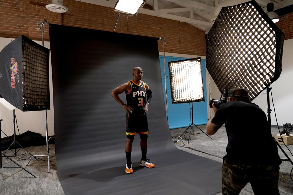 Phoenix Suns' Chris Paul poses for a photo with team photographer Barry Gossage during an NBA basketball media day, Monday, Sept. 26, 2022, in Phoenix. (AP Photo/Matt York)