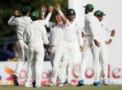 Pakistan's Yasir Shah (C) celebrates with his teammates after taking the wicket of Sri Lanka's Tharindu Kaushal (not pictured) during the second day of their second test cricket match against Pakistan in Colombo June 26, 2015. REUTERS/Dinuka Liyanawatte