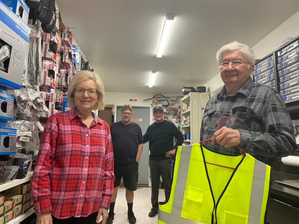 Judy and Dave Wolfe, the founders of Charity Bicycles in Brighton Township, show off upgrades to their bike repair and training center. In the background are customer Joe Burch (left) and board member Jeff Rey (right).