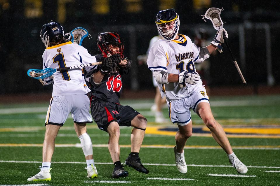 Lourdes' Drew Cornax, right, drives down field against Red Hook during an April 19, 2024 boys lacrosse game.