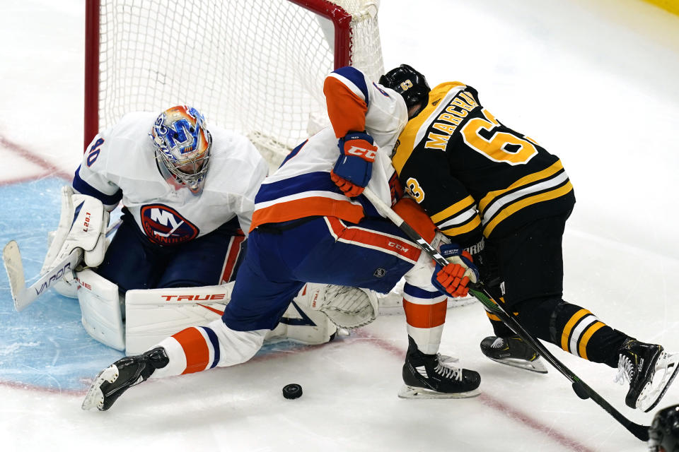 New York Islanders goaltender Semyon Varlamov (40) watches the puck as Islanders defenseman Adam Pelech (3) defends against Boston Bruins center Brad Marchand (63) during the third period of Game 5 of an NHL hockey second-round playoff series, Monday, June 7, 2021, in Boston. (AP Photo/Elise Amendola)