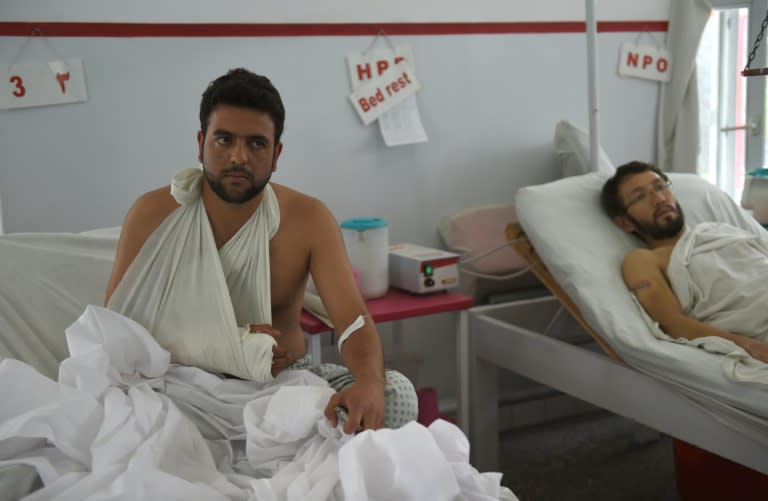 A wounded Afghan police man (L) is pictured at the Italian aid organization hospital in Kabul on August 25, 2016