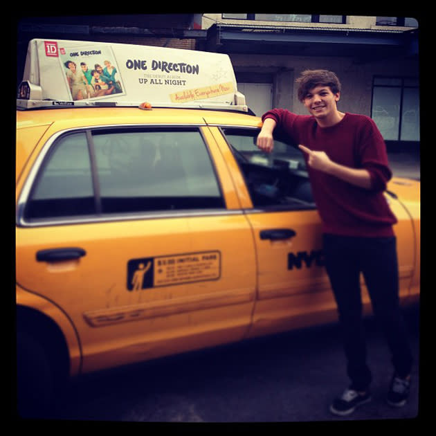 Celebrity photos: When Louis Tomlinson saw an advert for One Direction’s album on the top of an American taxi, he had to stop to capture the moment.