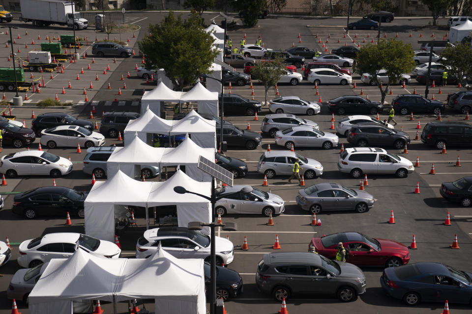 Motorists line up for their COVID-19 vaccine a joint state and federal mass vaccination site set up on the campus of California State University of Los Angeles in Los Angeles,Tuesday, Feb. 16, 2021. (AP Photo/Jae C. Hong)