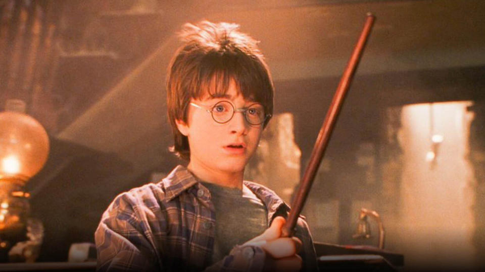 Daniel Radcliffe as Harry Potter, holding a wand in Harry Potter and the Sorceror's Stone