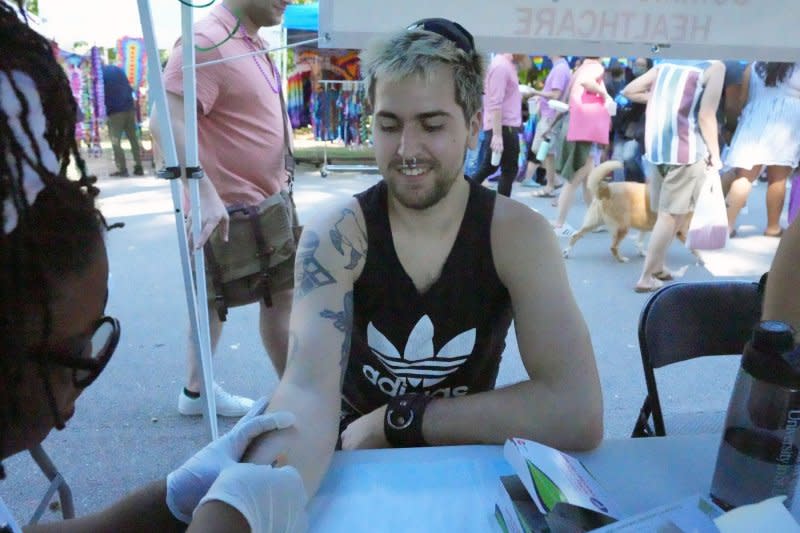 Mike Friedrich smiles as he is injected with the Monkeypox vaccine during the Tower Grove Pride in St. Louis on Sunday, September 25, 2022 when the virus caused a public health emergency. Health officials warn vaccination rates are down this year and cases are on the rise, twice as high as they were last year at this time. Photo by Bill Greenblatt/UPI