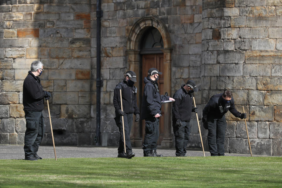 Police officers conduct a search within the grounds of the Palace of Holyroodhouse in Edinburgh. (PA Images)