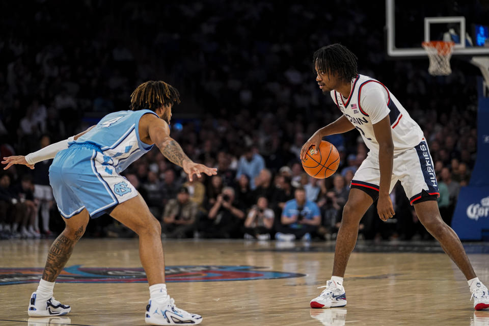 North Carolina guard RJ Davis defends UConn guard Tristen Newton during the first half of an NCAA college basketball game in New York, Tuesday, Dec. 5, 2023. (AP Photo/Peter K. Afriyie)