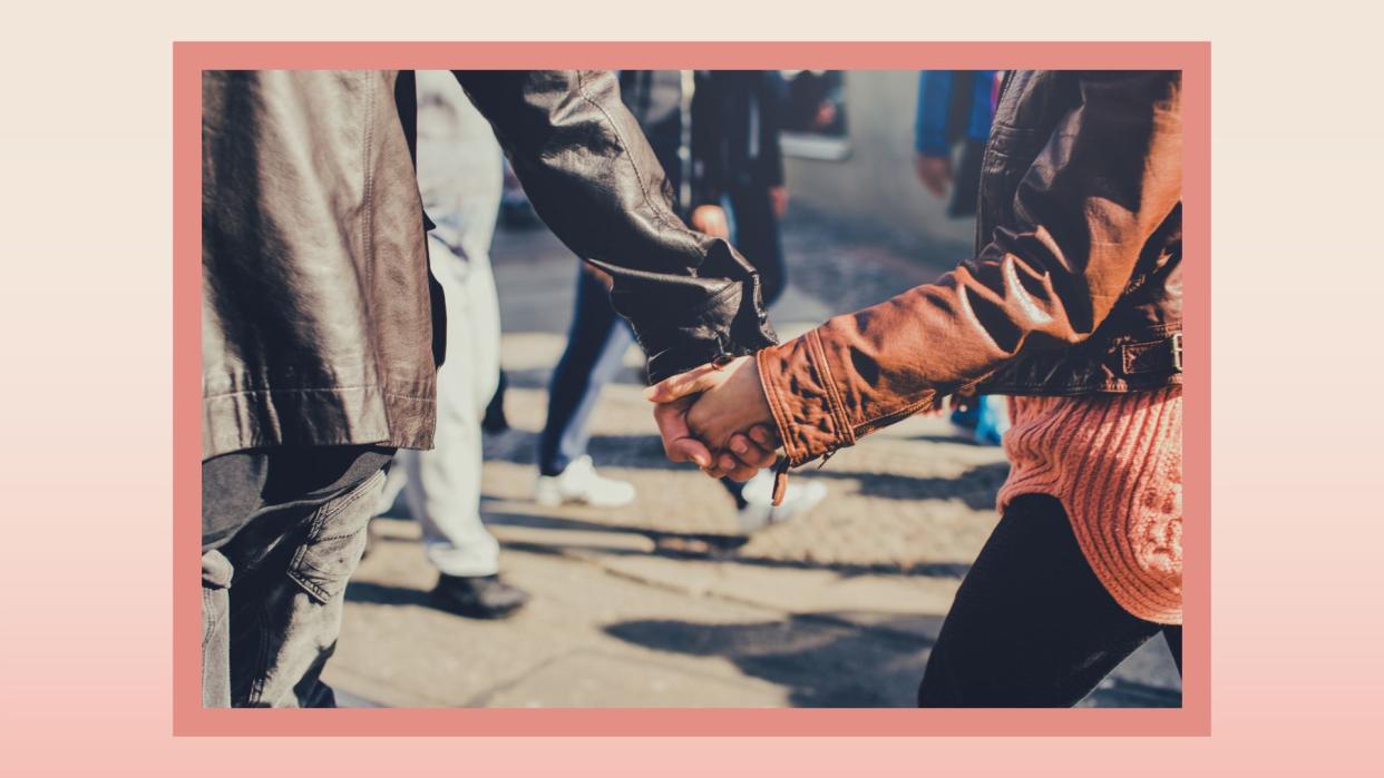  the lower half of a couple's body walking outside in the fall where the man is ahead of the woman 