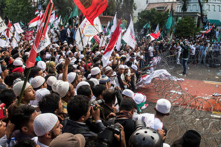 Muslim students broke the barb wire during a protest against Jakarta's incumbent governor Basuki Tjahaja Purnama. Antara Foto/M Agung Rajasa/via REUTERS