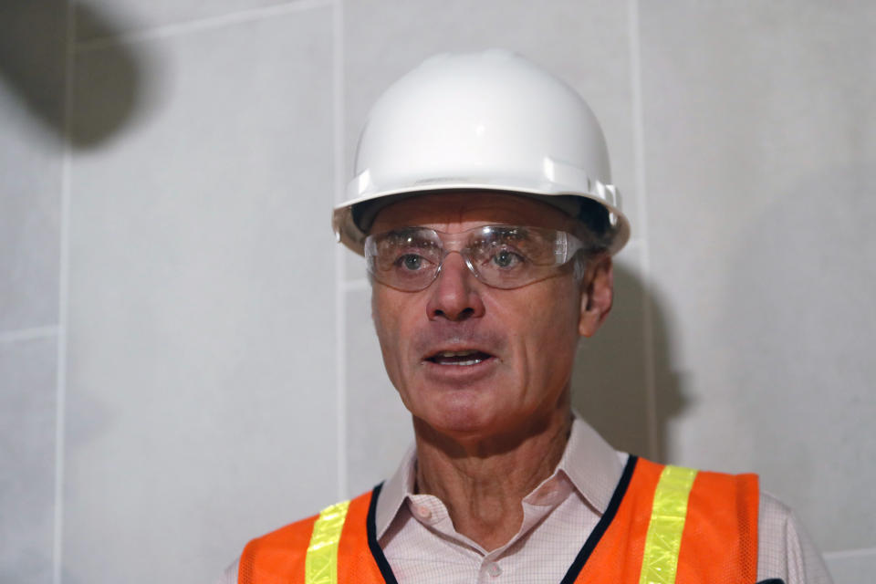 Baseball Commissioner Rob Manfred speaks to the media during a tour of the new under construction Texas Rangers stadium in Arlington, Texas, Tuesday, Nov. 19, 2019. Manfred hopes the investigation into sign stealing by the Houston Astros will be completed by next season and says he has broad authority to impose discipline beyond fines, the loss of amateur draft picks and taking away international signing bonus pool allocation. (AP Photo/LM Otero)