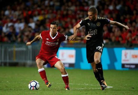 Soccer Football - Leicester City v Liverpool - Pre Season Friendly - The Premier League Asia Trophy - Final - June 22, 2017 Liverpool's Philippe Coutinho in action with Leicester City's Islam Slimani REUTERS/BOBBY YIP