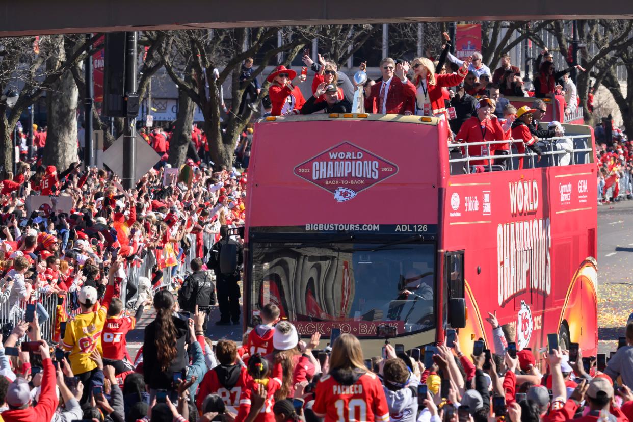 Kansas City Chiefs chairman and CEO Clark Hunt holds the Vince Lombardi Trophy as their bus arrives at the victory rally in Kansas City, Mo., Wednesday, Feb. 14, 2024.