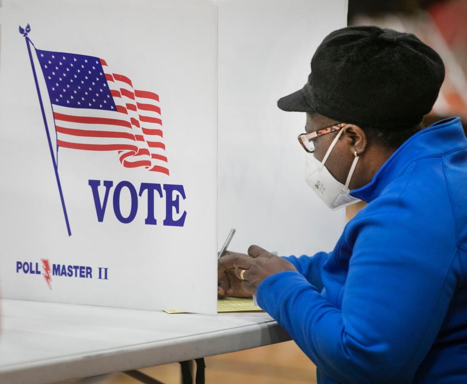 A woman votes at Creekside Elementary in Fairfield, Ohio, on Election Day, Tuesday, Nov. 3, 2020.