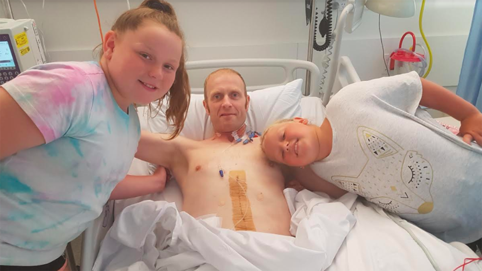 Wayne Gair, pictured here with two of his children, had to have a 12 kilogram tumour removed from his abdomen. Source: 7News