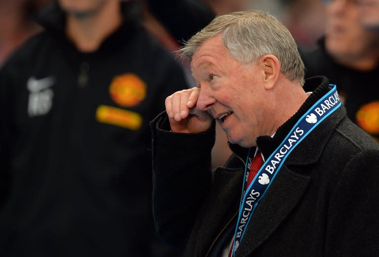 Manchester United's Scottish manager Alex Ferguson wipes his face after receiving his Premier League championship medal at the end of the English Premier League football match between Manchester United and Swansea City at Old Trafford in Manchester, northwest England, on May 12, 2013