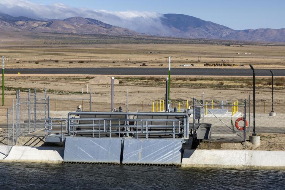 A water facility sits in a desert landscape.