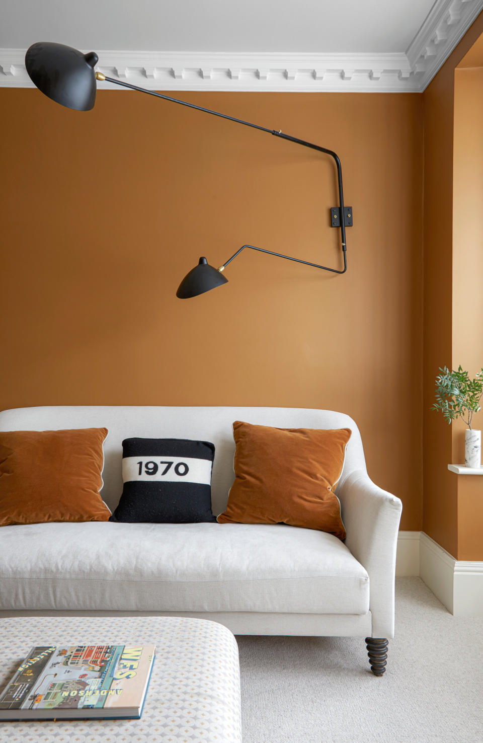 Orange living room with white ceiling and white sofa