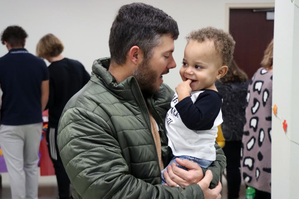 Hadley Smith plays with his, now official, son Jaylen Smith during the National Adoption Day event at the Randall County Courthouse on Nov. 18 in Canyon.