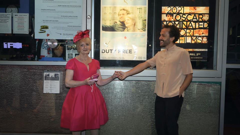 Rebecca Danigelis and her son Sian-Pierre Regis are photographed in front of a poster for the documentary, 