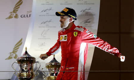 Formula 1 F1 - Bahrain Grand Prix - Bahrain International Circuit, Sakhir, Bahrain - April 8, 2018 Ferrari's Sebastian Vettel celebrates with the trophy after winning the race REUTERS/Ahmed Jadallah