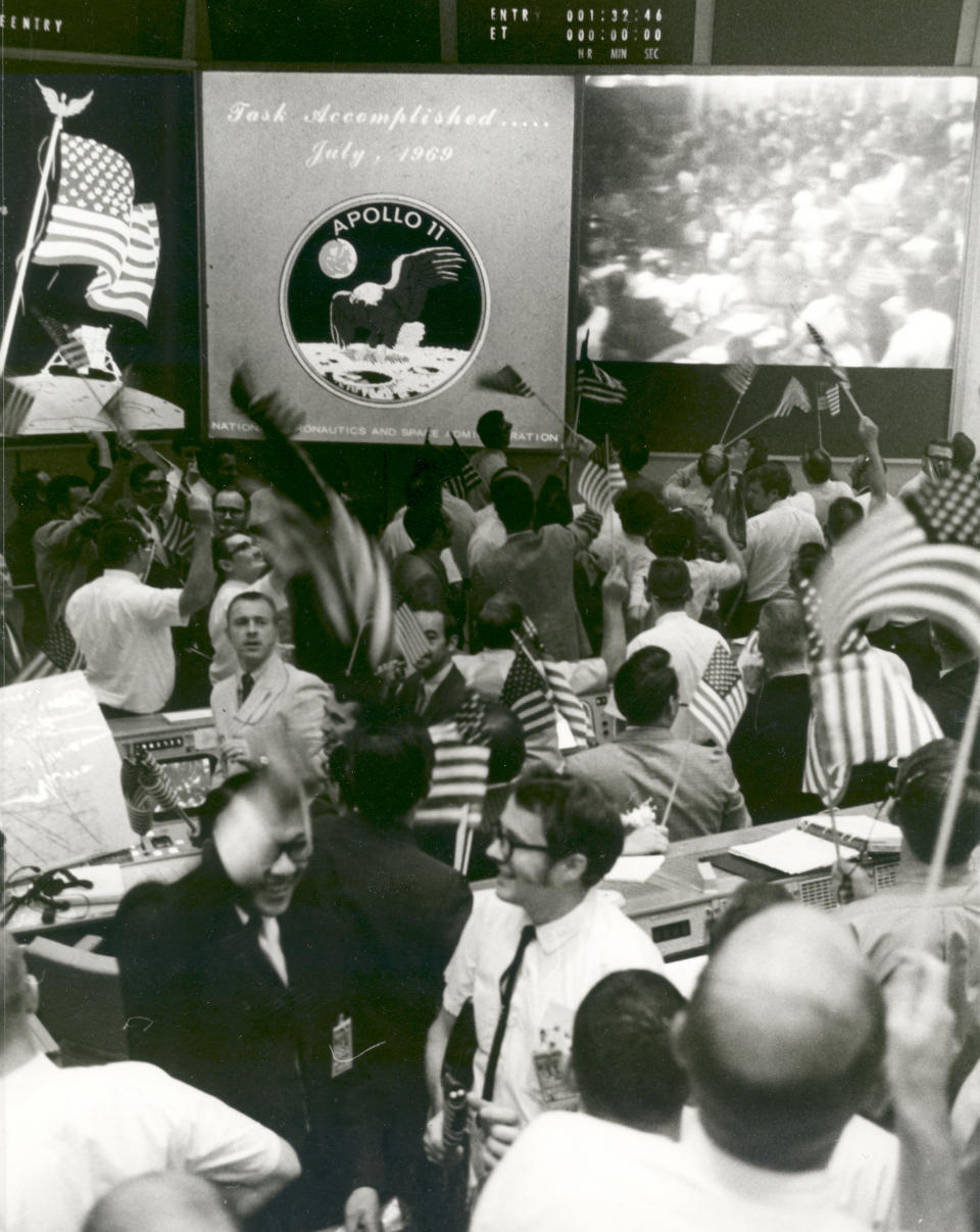 Overall view of the Mission Operations Control Room in the Mission Control Center, Building 30, Manned Spacecraft Center, showing the flight controllers celebrating the successful conclusion of the Apollo 11 lunar landing mission on July 24, 1969.  (Photo: NASA)