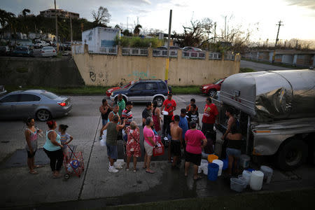 Local residents wait in line during a water distribution in Bayamon following damages caused by Hurricane Maria in Las Piedras, Las Piedras, October 1, 2017 REUTERS/Carlos Barria