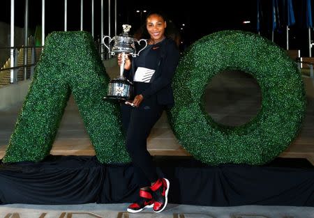 FILE PHOTO - Tennis - Australian Open - Melbourne Park, Melbourne, Australia - early 29/1/17 Serena Williams of the U.S. poses with the Women's singles trophy after winning her final match. REUTERS/Thomas Peter/Files