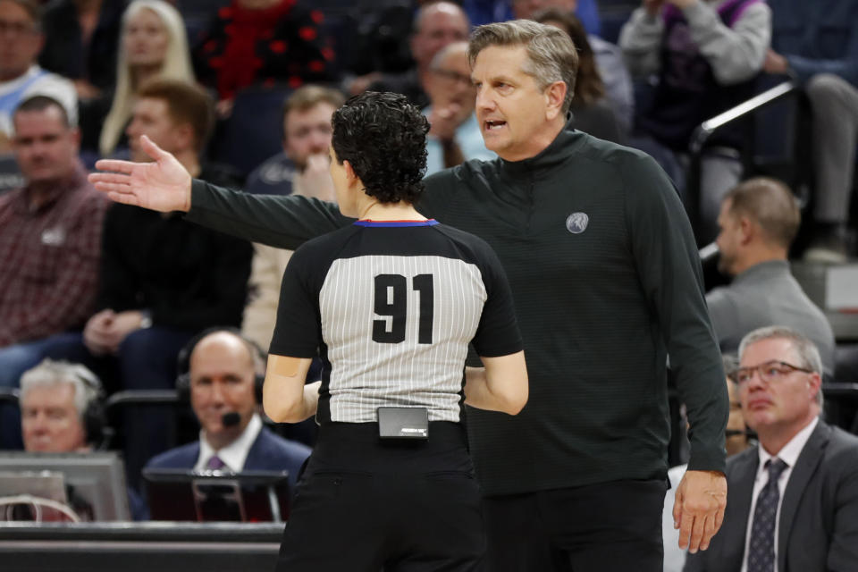 Minnesota Timberwolves head coach Chris Finch talks about a call with referee Cheryl Flores in the fourth quarter of an NBA basketball game with the Atlanta Hawks Wednesday, March 22, 2023, in Minneapolis. The Timberwolves won 125-124. (AP Photo/Bruce Kluckhohn)