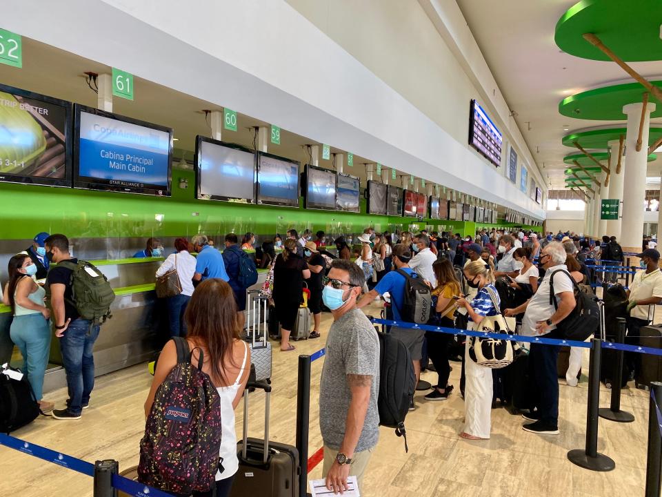 Tourists wait fot their turn at the counters at the Punta Cana International Airport (PUJ), in Dominican Republic on December 5, 2020 amid the covid-19 coronavirus pandemic. (Photo by Daniel SLIM / AFP) (Photo by DANIEL SLIM/AFP via Getty Images)