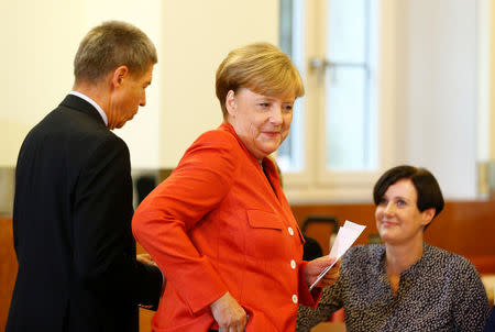 German Chancellor and leader of the Christian Democratic Union CDU Angela Merkel prepares to vote in the general election (Bundestagswahl) in Berlin, Germany, September 24, 2017. REUTERS/Ralph Orlowski