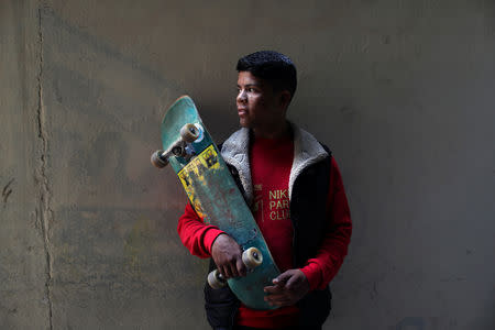 Palestinian Mustafa Sarhan, 19, a member of Gaza Skating Team, holds a skateboard as he poses for a portrait in his family house in Gaza City March 18, 2019. REUTERS/Mohammed Salem