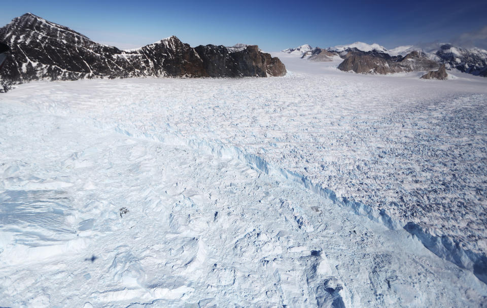 <p>A glacier is seen from NASA’s Operation IceBridge research aircraft, in the Antarctic Peninsula region, on Oct. 31, 2017, above Antarctica. (Photo: Mario Tama/Getty Images) </p>