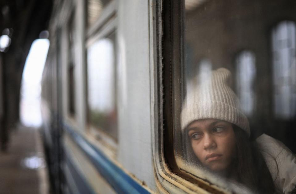 A girl looks out from a window as she waits inside a train taking refugees to Poland at Lviv train station, western Ukraine, on March 5, 2022. The UN Human Rights Council on March 4, 2022, overwhelmingly voted to create a top-level investigation into violations committed following Russia's invasion of Ukraine. More than 1.2 million people have fled Ukraine into neighbouring countries since Russia launched its full-scale invasion on Feb. 24, United Nations figures showed on March 4, 2022. (Daniel Leal / AFP via Getty Images)