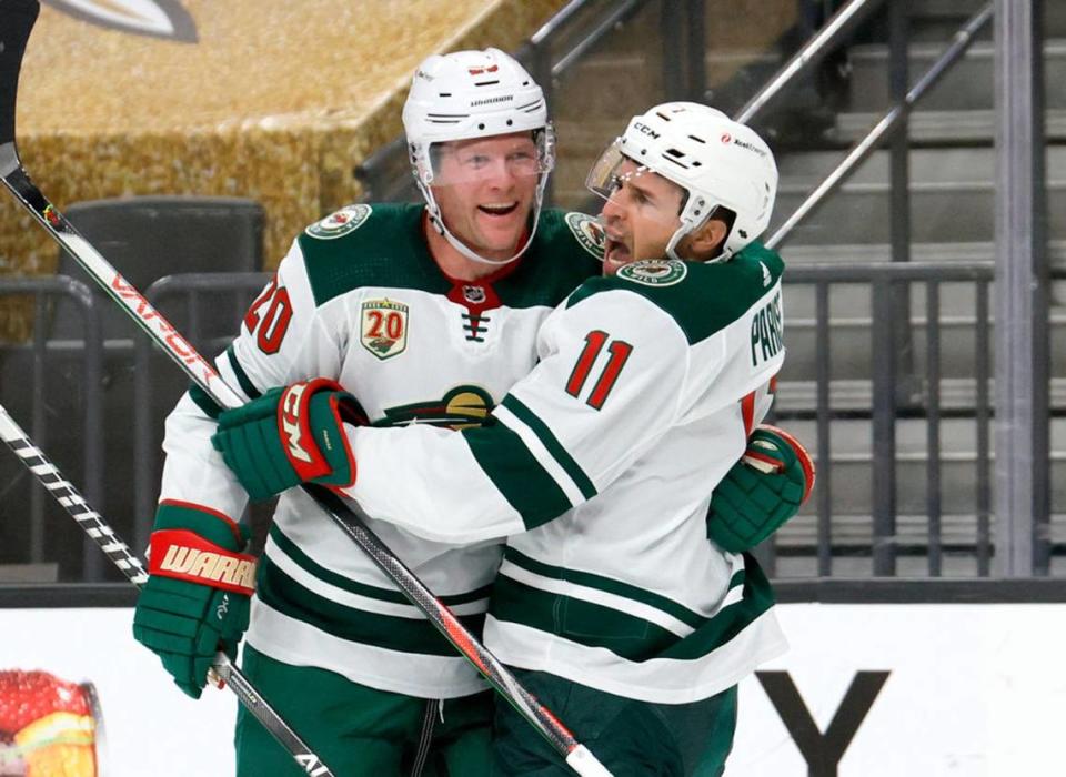 Ryan Suter #20 and Zach Parise #11 of the Minnesota Wild celebrate after Suter assisted Parise on a first-period goal against the Vegas Golden Knights in Game Seven of the First Round of the 2021 Stanley Cup Playoffs at T-Mobile Arena on May 28, 2021 in Las Vegas, Nevada. (Ethan Miller/Getty Images/TNS)