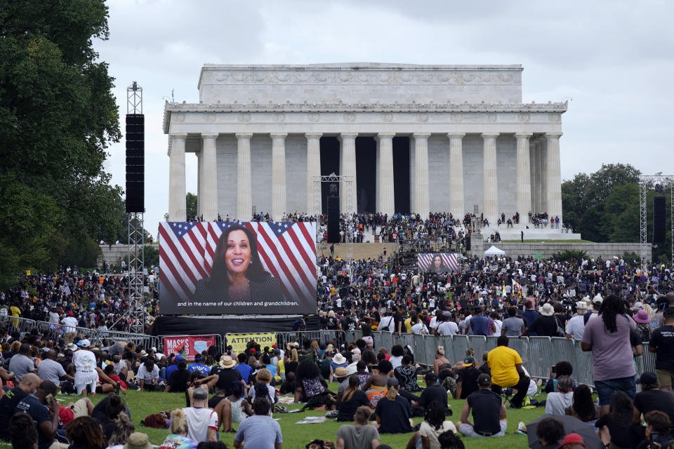 FILE - In this Aug. 28, 2020, file photo, a screen displays a video with Democratic vice presidential candidate Kamala Harris speaking during the March on Washington at the Lincoln Memorial in Washington, on the 57th anniversary of the Rev. Martin Luther King Jr.'s "I Have A Dream" speech. A tough road lies ahead for Biden who will need to chart a path forward to unite a bitterly divided nation and address America’s fraught history of racism that manifested this year through the convergence of three national crises. (AP Photo/Carolyn Kaster, File)