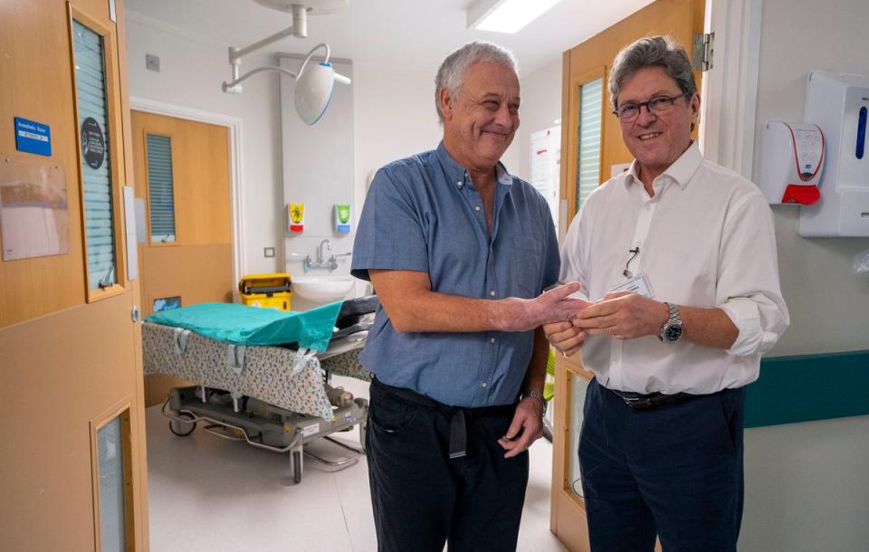 Hand transplant patient Mark Cahill with surgeon Simon Kay at Leeds General Infirmary (PA)