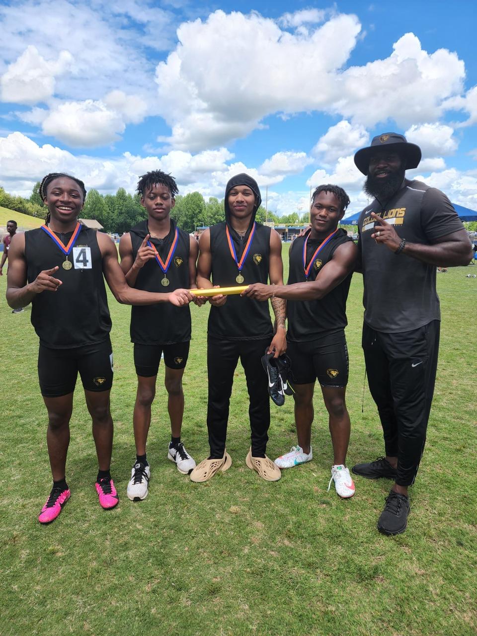 The Shelby boys 4x100-meter track team celebrates its 2A West regional title on May 13, 2022.