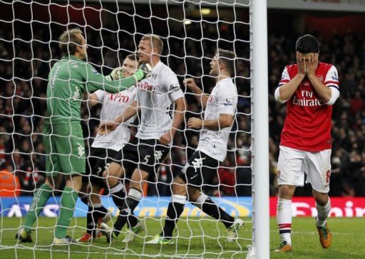 Fulham's goalkeeper Mark Schwarzer (L) celebrates saving the penalty taken by Arsenal's Mikel Arteta (R) during an English Premier League football match between Arsenal and Fulham at the Emirates Stadium in London. The match ended in a 3-3 draw