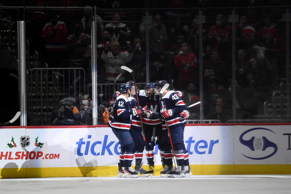 Washington Capitals left wing Alex Ovechkin (8) celebrates his goal with defenseman Martin Fehervary (42), right wing Tom Wilson (43) and others during the second period of an NHL hockey game against the Columbus Blue Jackets-, Saturday, Dec. 4, 2021, in Washington. (AP Photo/Nick Wass)